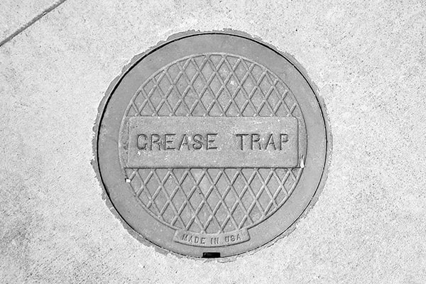 grease trap pumping typically involves the use of vacuum trucks or pump trucks to remove the accumulated grease and oil